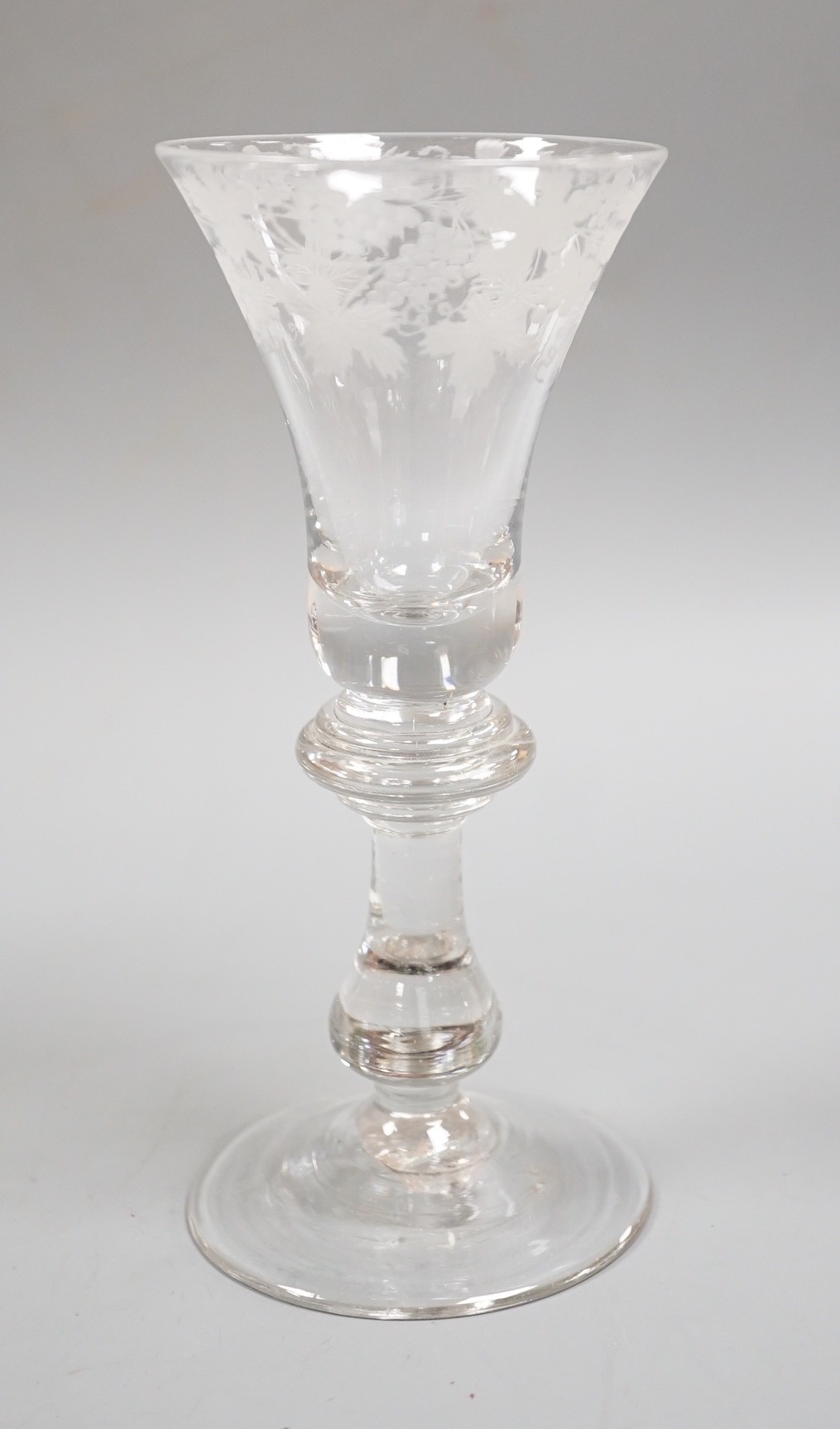 An engraved baluster stem wine glass, 17cm
